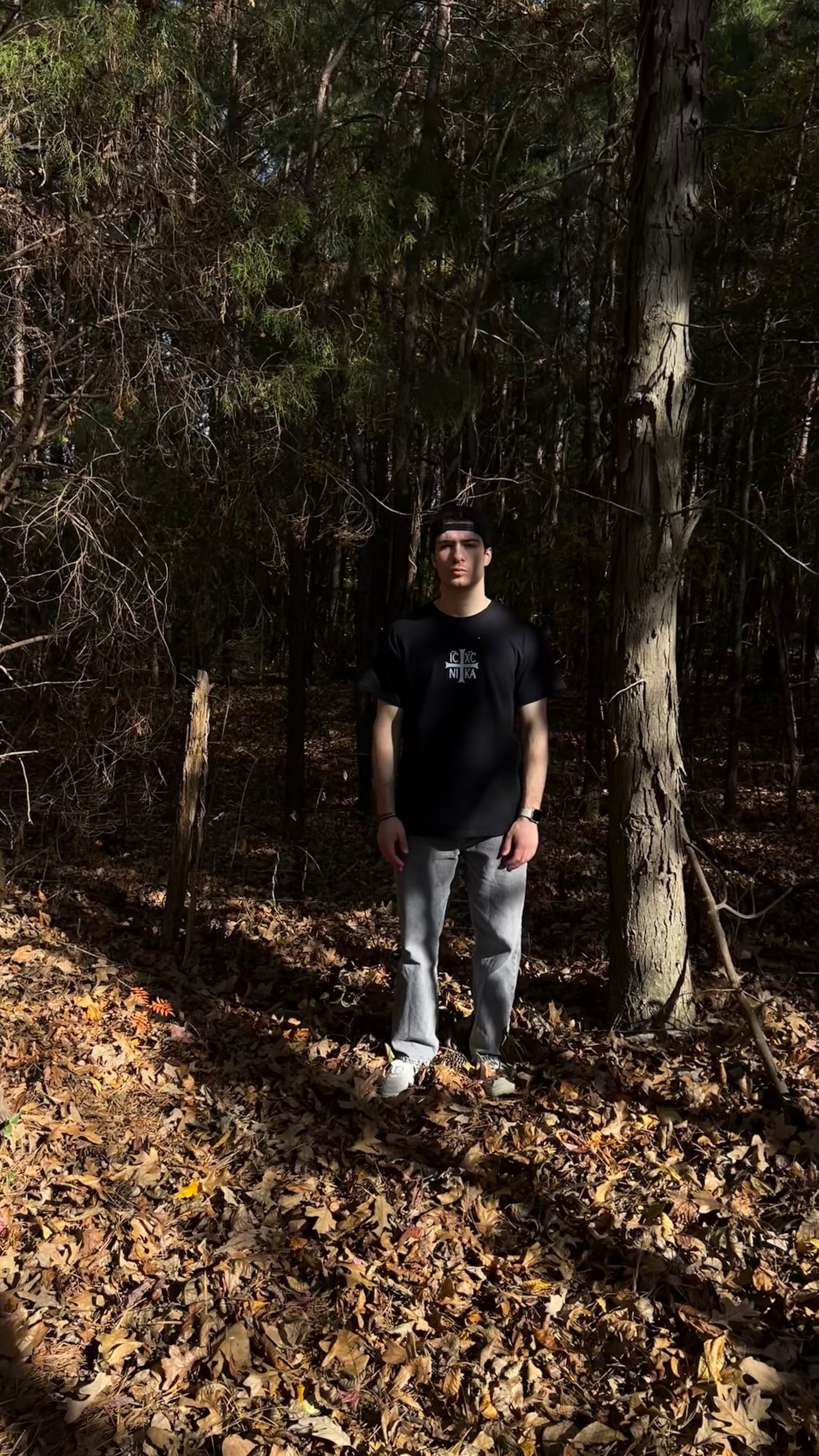 Black Orthodox Christian T-Shirt being worn in a forest