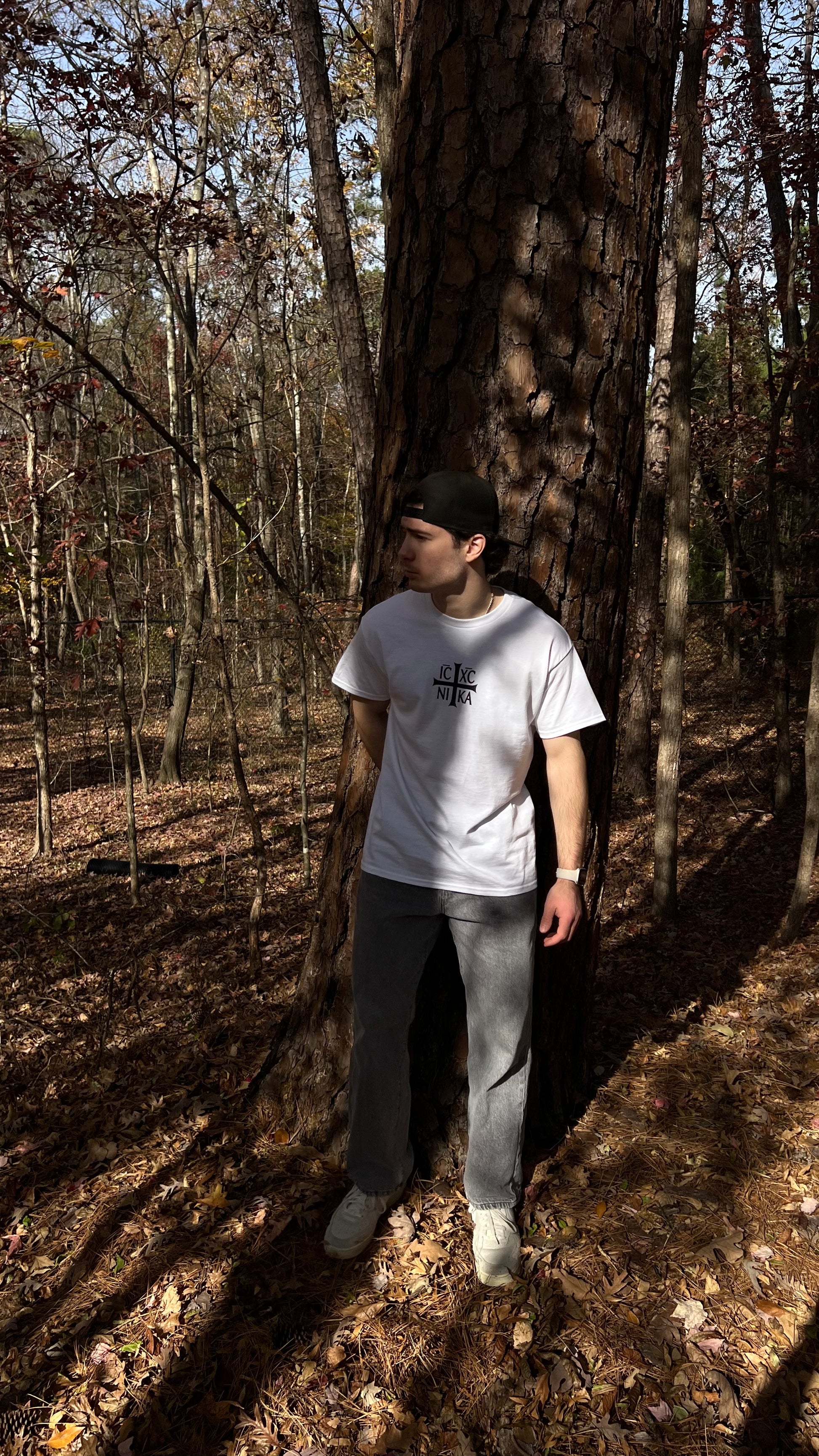 Man wearing white Orthodox Christian T-Shirt in the forest